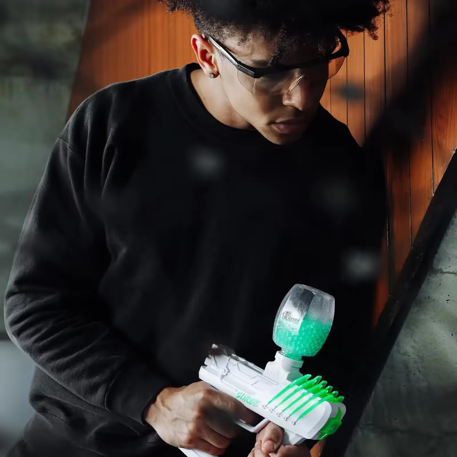 Close-up portrait of a gel blaster player in full gear during a match